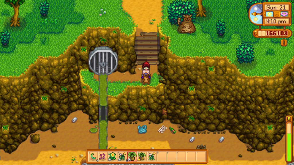 A screenshot from Stardew Valley where the player is standing next to a sewer and looking at trash.